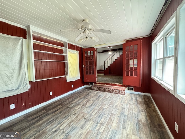 spare room with wood-type flooring, wooden walls, and wood ceiling