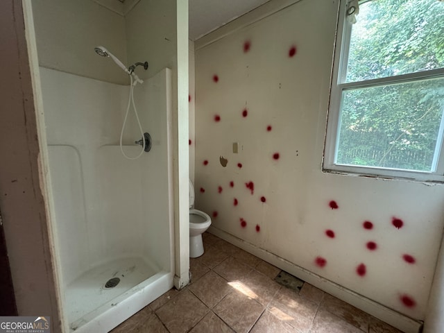 bathroom featuring tile patterned floors, walk in shower, and toilet