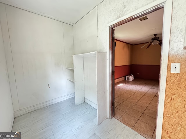 empty room featuring ceiling fan and light tile patterned floors