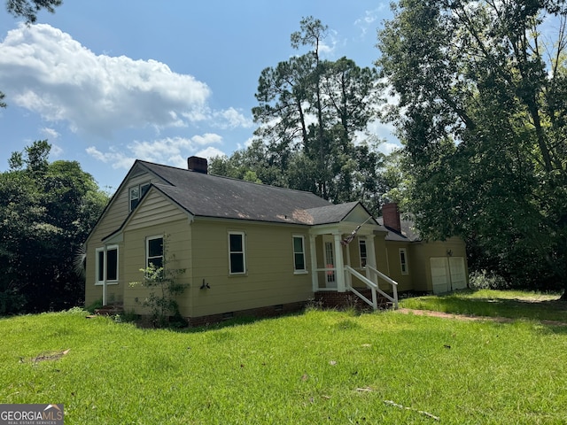 rear view of property featuring a yard