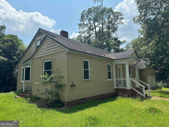 view of side of home featuring a yard