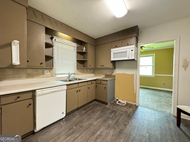 kitchen featuring sink, tasteful backsplash, dark wood-type flooring, and white appliances