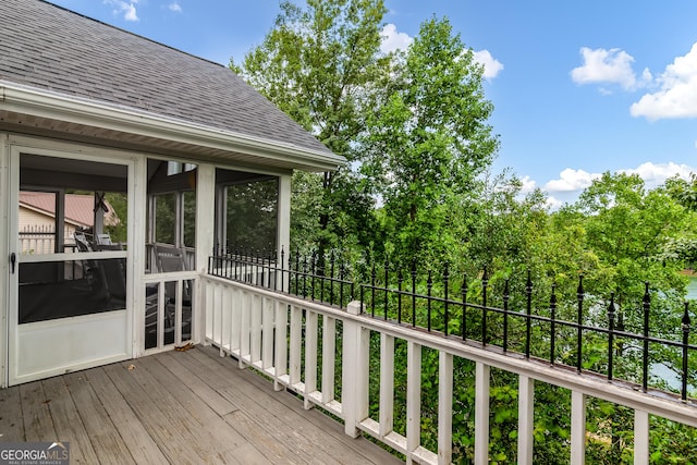 wooden deck with a sunroom