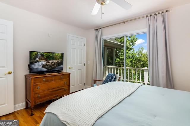 bedroom featuring hardwood / wood-style flooring, ceiling fan, and access to outside