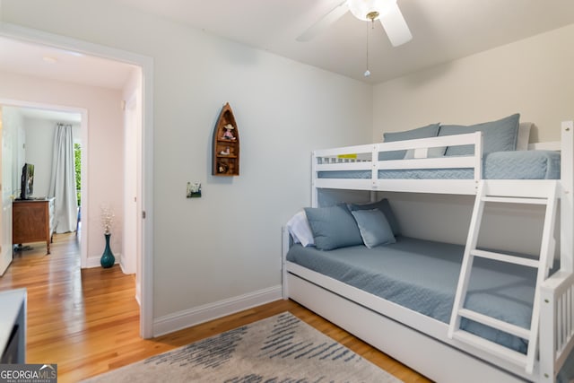 bedroom with hardwood / wood-style floors and ceiling fan