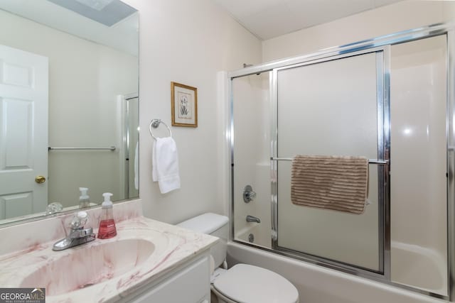 full bathroom featuring vanity, toilet, and bath / shower combo with glass door