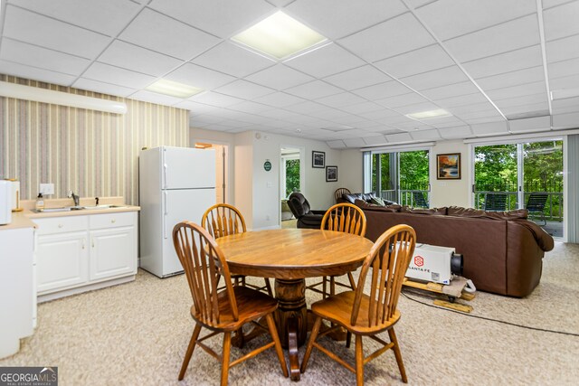 dining room with a drop ceiling and sink