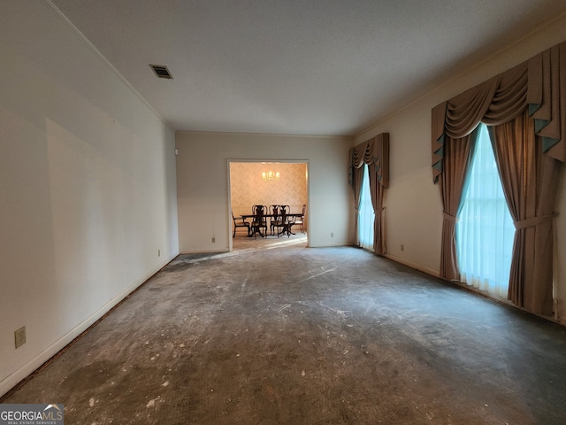 unfurnished living room with concrete floors and a textured ceiling