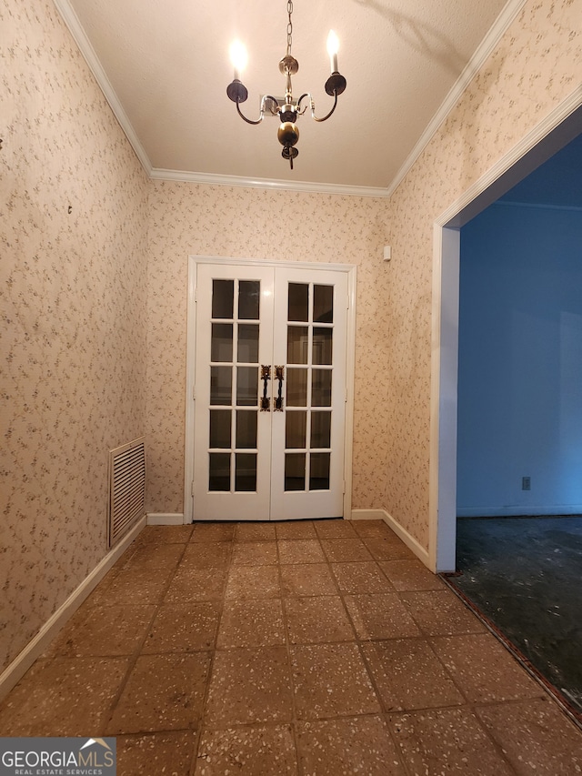 interior space with a notable chandelier, french doors, ornamental molding, and tile patterned flooring