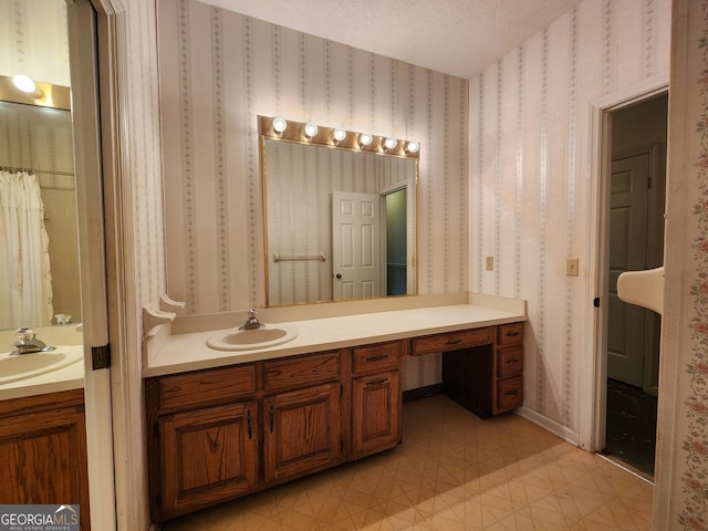 bathroom with tile patterned floors, vanity, and a textured ceiling