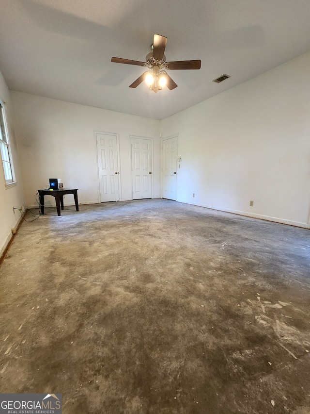 spare room featuring concrete flooring and ceiling fan