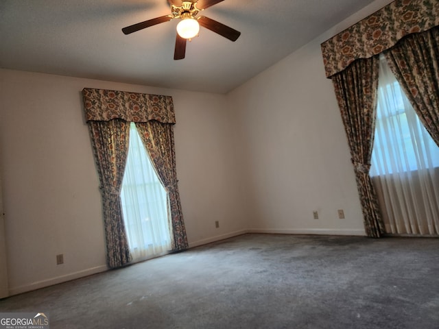 carpeted empty room featuring ceiling fan