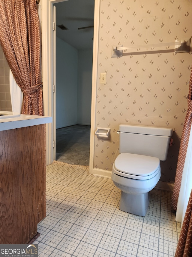 bathroom with tile patterned floors, vanity, and toilet