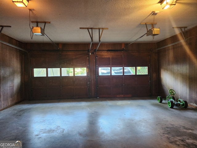 garage with wooden walls and a garage door opener