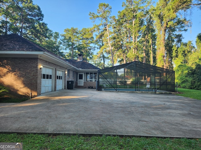 exterior space with a lanai and a garage