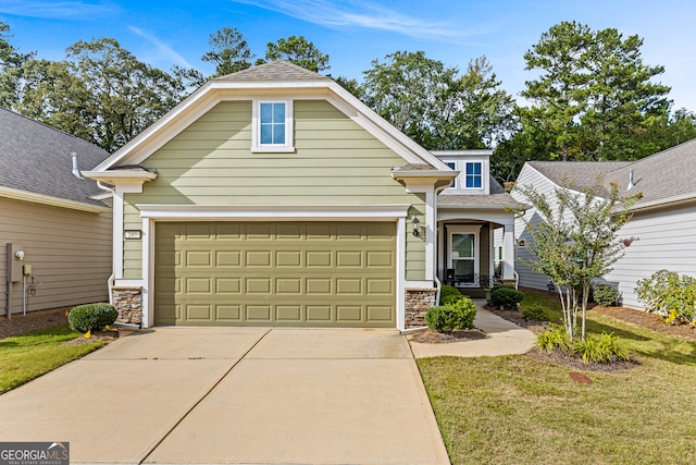 view of front of house featuring a garage and a front lawn