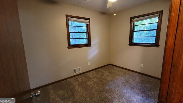 unfurnished room featuring ceiling fan and carpet flooring