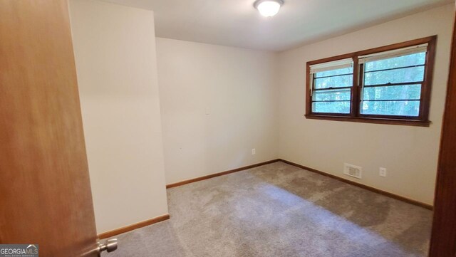 empty room featuring light carpet