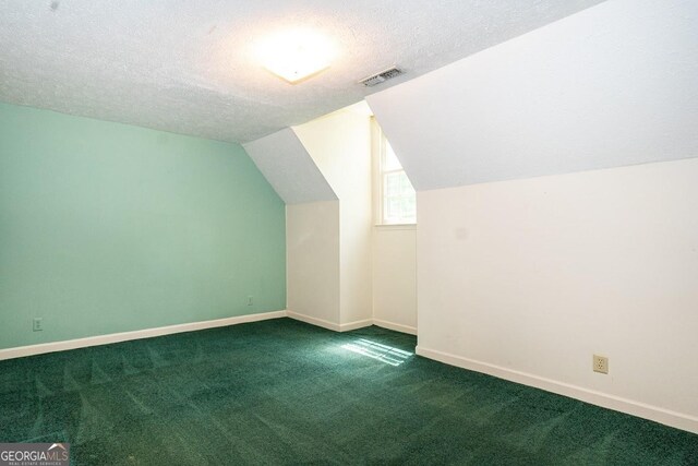 bonus room with lofted ceiling, a textured ceiling, and carpet floors