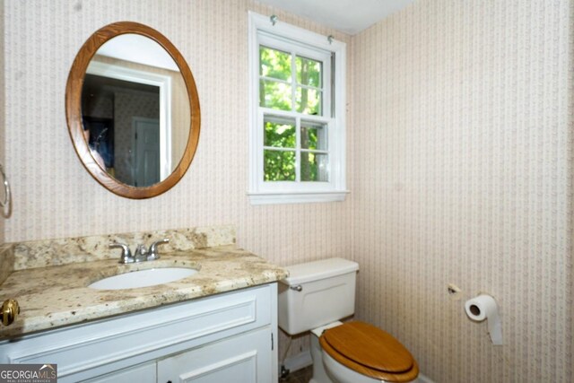 bathroom featuring vanity and toilet