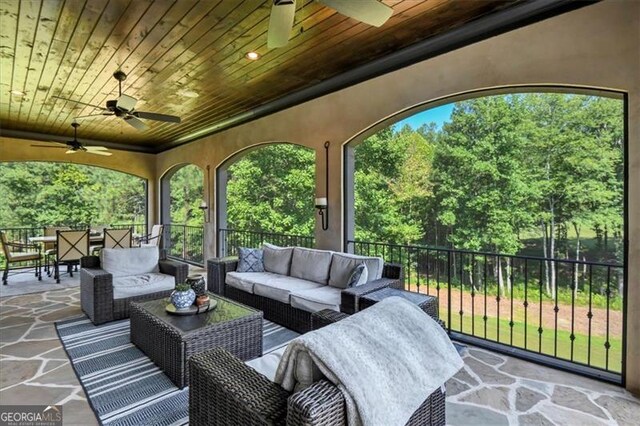 view of patio with ceiling fan and an outdoor living space