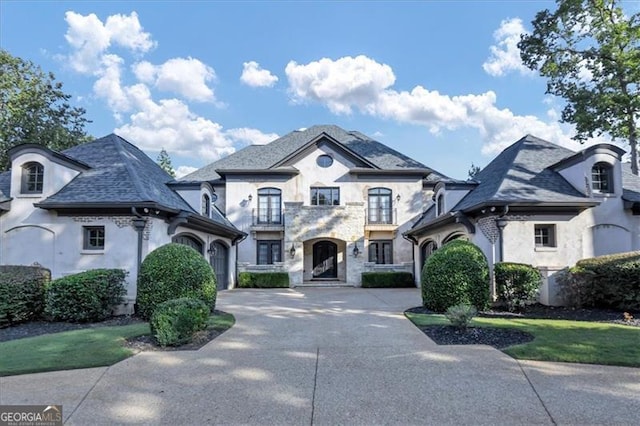 french country style house featuring a garage