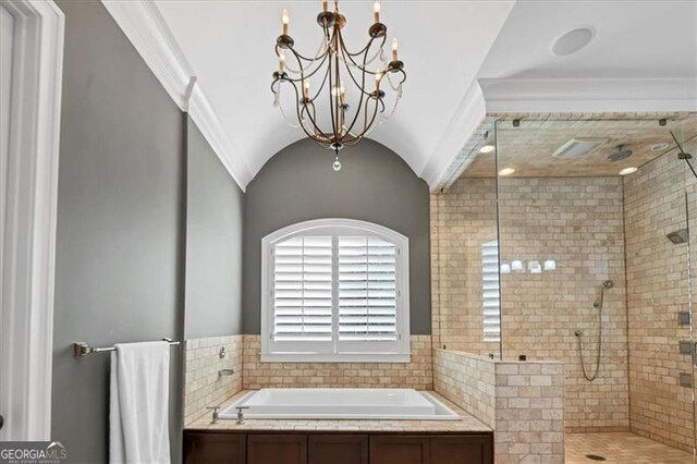 bathroom featuring independent shower and bath, vaulted ceiling, an inviting chandelier, and crown molding