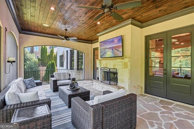 view of patio / terrace with ceiling fan, an outdoor living space, and french doors