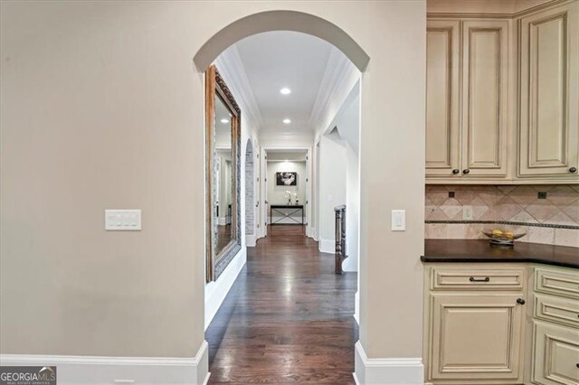 hall with dark hardwood / wood-style floors and crown molding