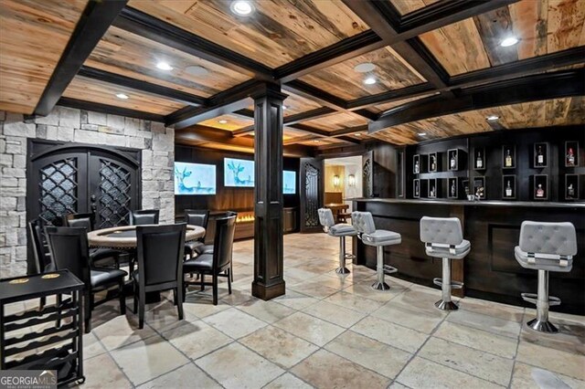 bar featuring light tile patterned flooring, french doors, and coffered ceiling