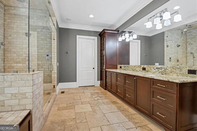 bathroom featuring tile patterned flooring, crown molding, vanity, and a shower with shower door