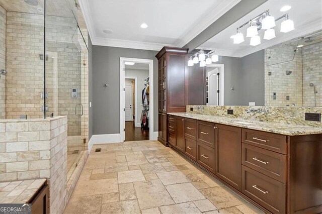 bathroom with tile patterned flooring, crown molding, vanity, and walk in shower