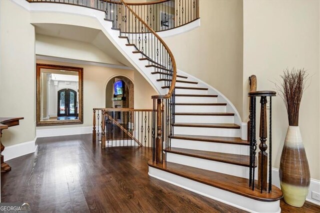 stairway featuring wood-type flooring