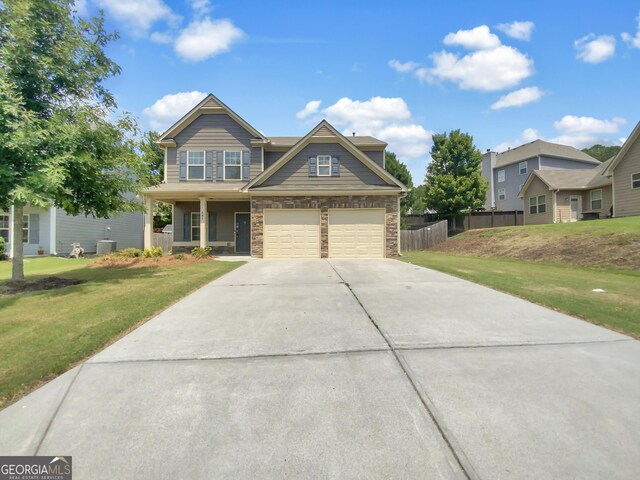 craftsman-style house featuring central AC, a front yard, and a garage