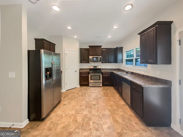 kitchen featuring light tile patterned floors, sink, stainless steel appliances, and dark brown cabinetry