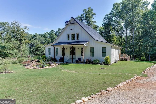 modern farmhouse style home with a front lawn and covered porch