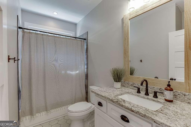 bathroom featuring vanity, toilet, and a shower with curtain