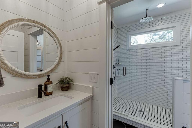 bathroom with walk in shower and vanity