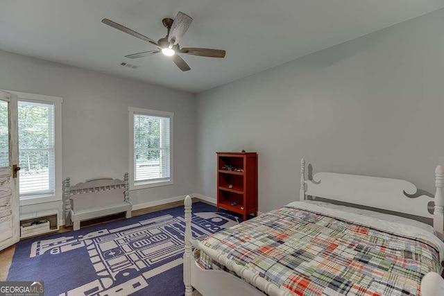 bedroom with ceiling fan and hardwood / wood-style floors