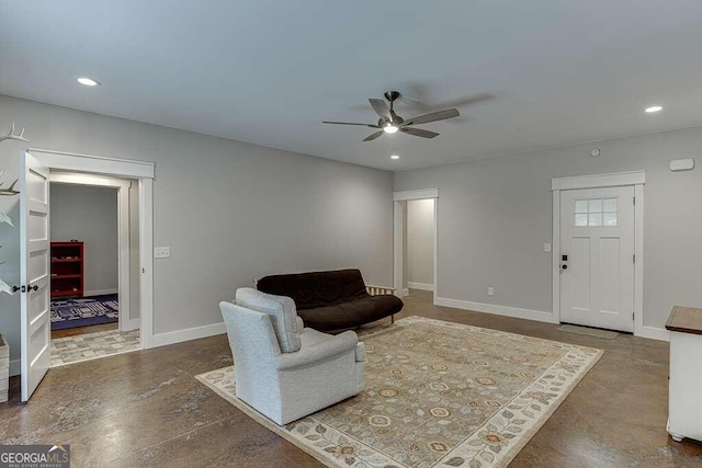 living room featuring concrete flooring and ceiling fan