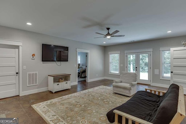 living room featuring ceiling fan and french doors