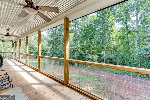 unfurnished sunroom featuring ceiling fan