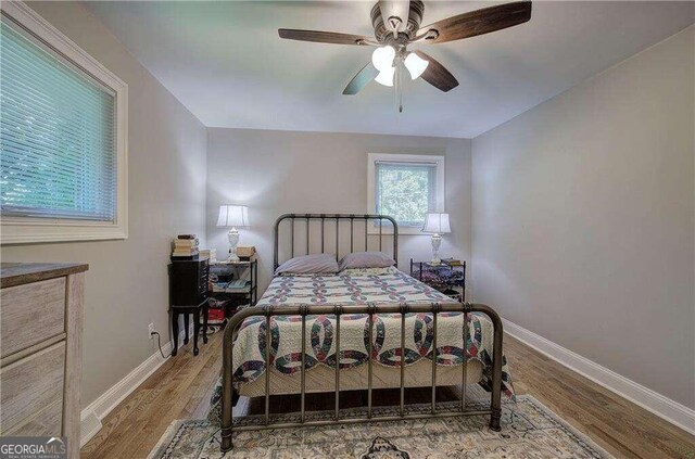 bedroom with ceiling fan and light hardwood / wood-style flooring