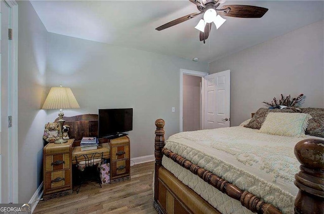 bedroom with hardwood / wood-style floors and ceiling fan