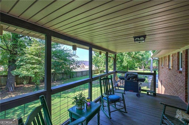 wooden deck featuring a yard and grilling area