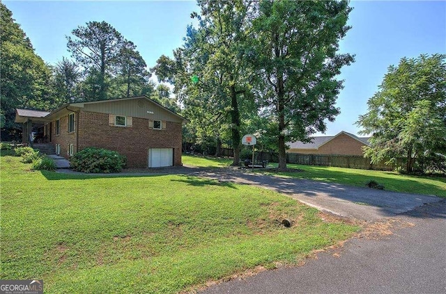 view of home's exterior with a lawn and a garage