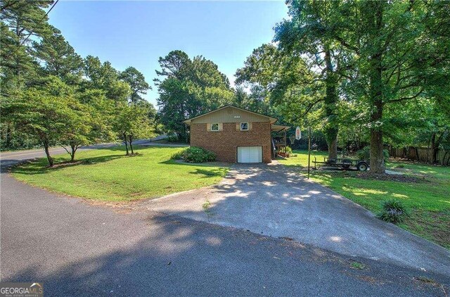 view of front facade with a front lawn and a garage