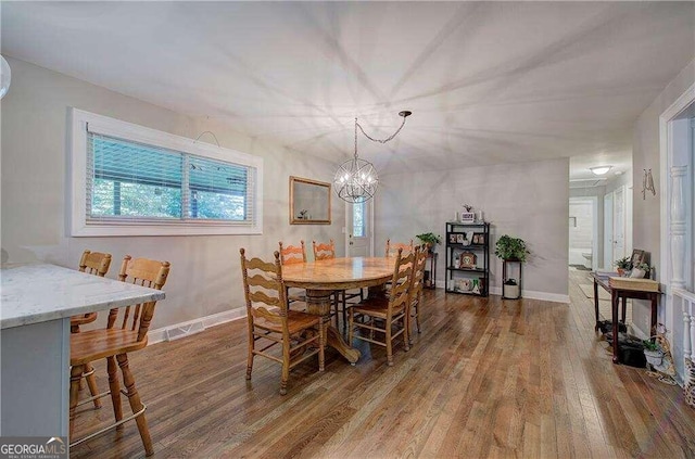 dining room featuring a notable chandelier and wood-type flooring