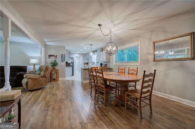 dining area featuring a notable chandelier and wood-type flooring