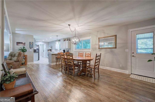 dining space featuring a chandelier and hardwood / wood-style floors